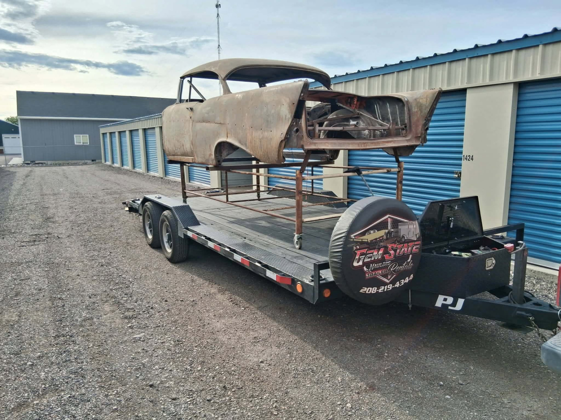 Classic car body project loaded on a Gem State Haulers flatbed trailer