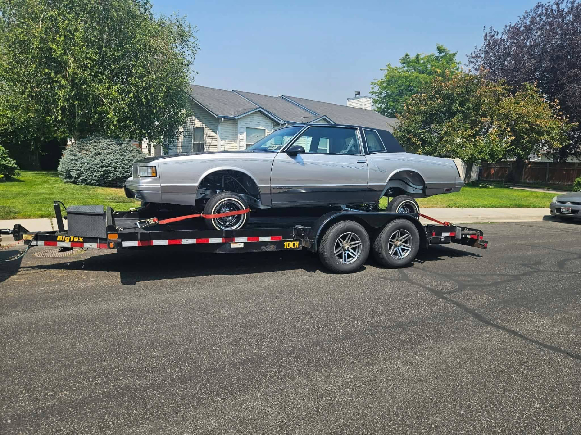 Silver classic car secured on a Gem State Haulers car trailer